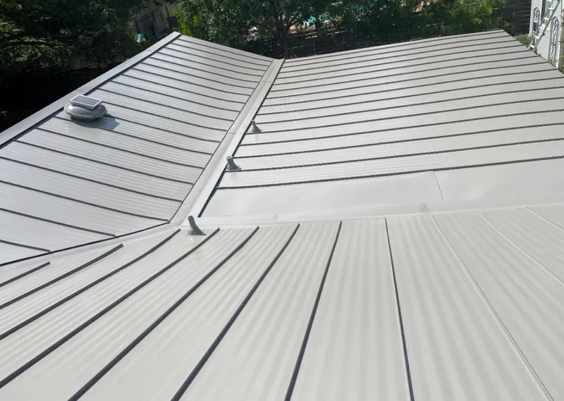 Solar attic fan installed on a metal roof for Roof Ventilation in Rupert